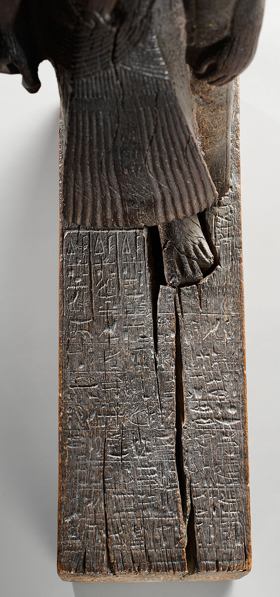 Statuette of Kary carrying a standard of Horus, Wood