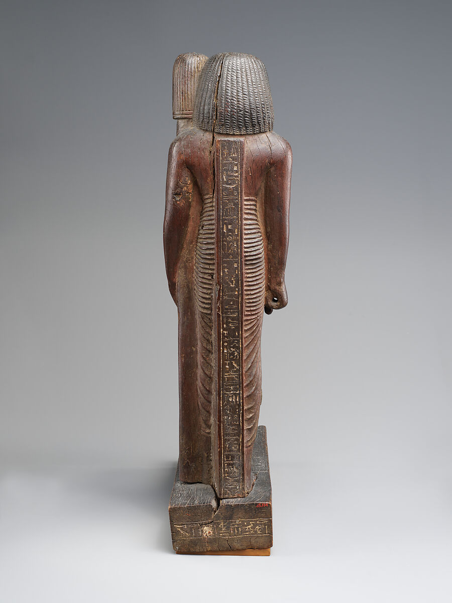 Statuette of Kary carrying a standard of Horus, Wood