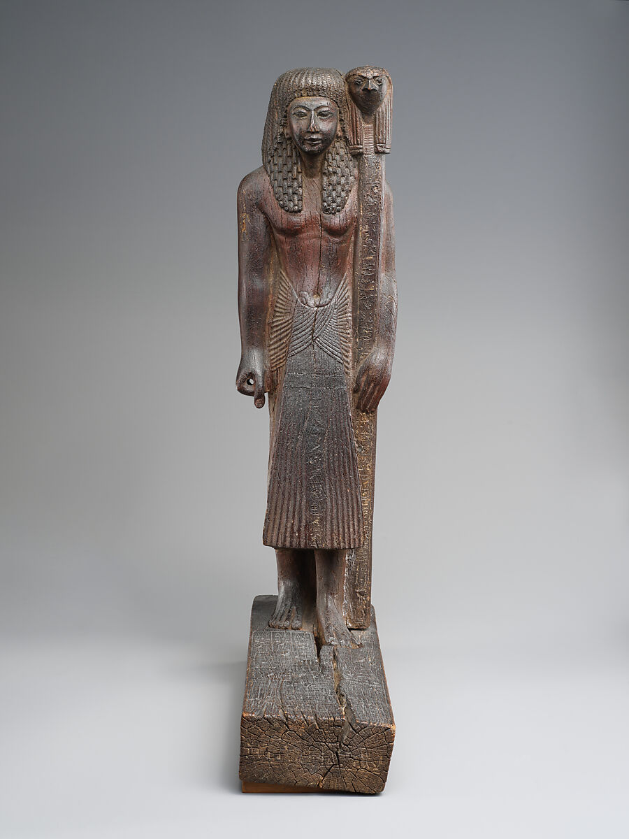 Statuette of Kary carrying a standard of Horus, Wood