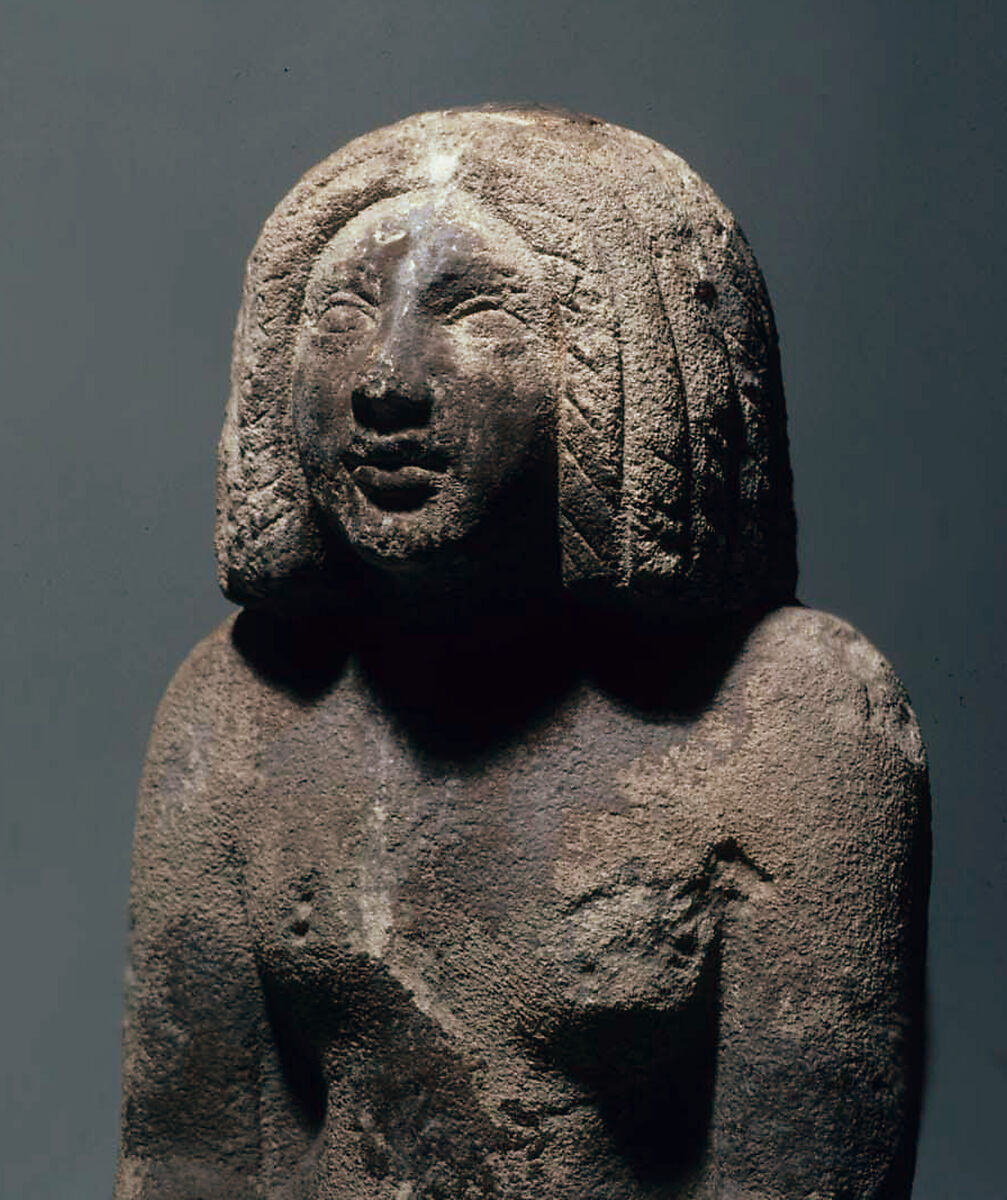 Seated woman, Sandy fossiliferous limestone