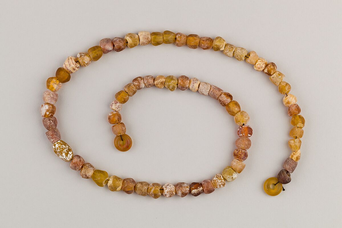 String of 70 beads, Amber glass 