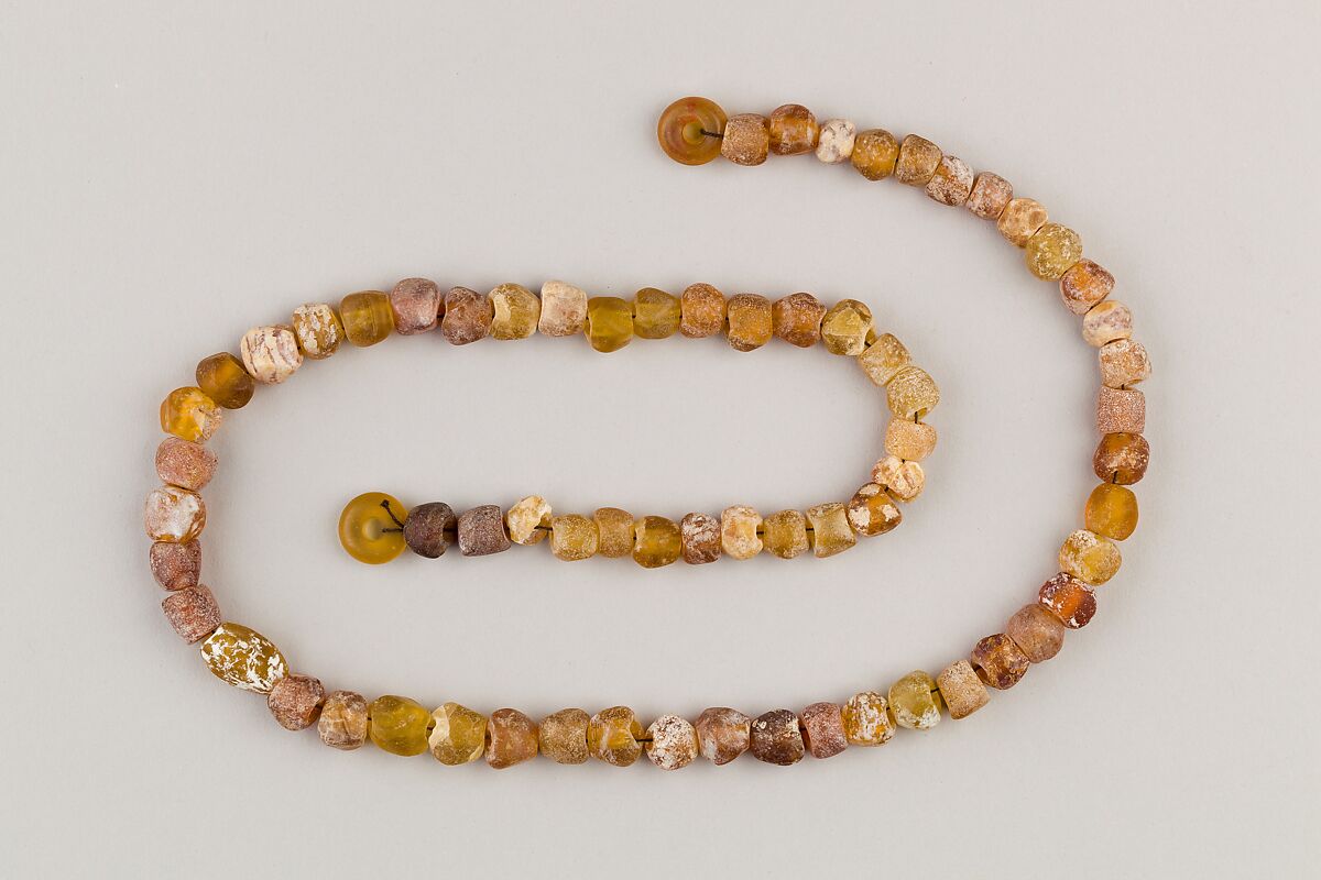 String of 70 beads, Amber glass