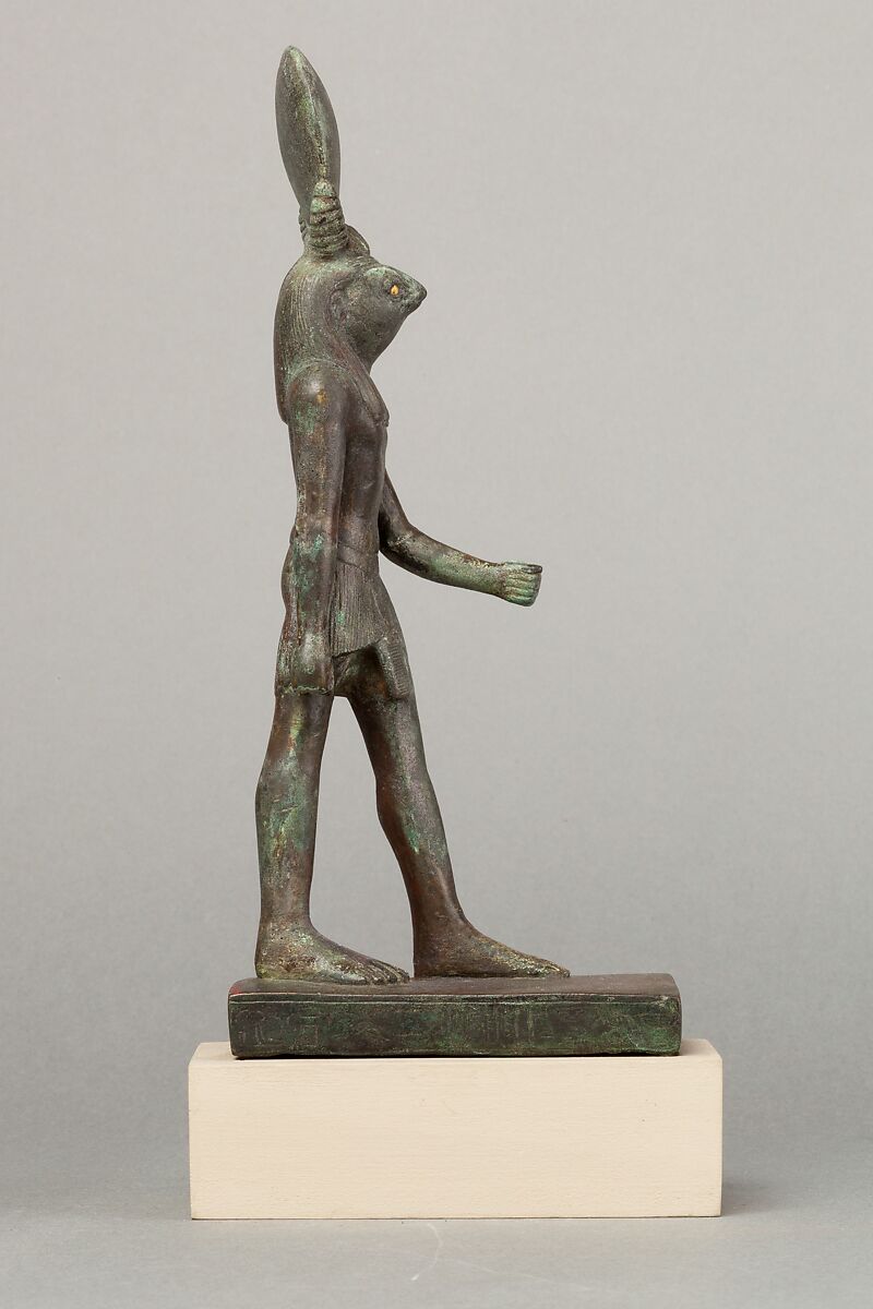 An ancient base asking blessings from Heka for the Scribe of the Library of Atum Pa-kap, son of the Prophet of Atum Pa-iry-kap and the mistress of the House Hr-ib-Wadjet; statue modern above the ankles, Bronze, brass, precious metal inlay