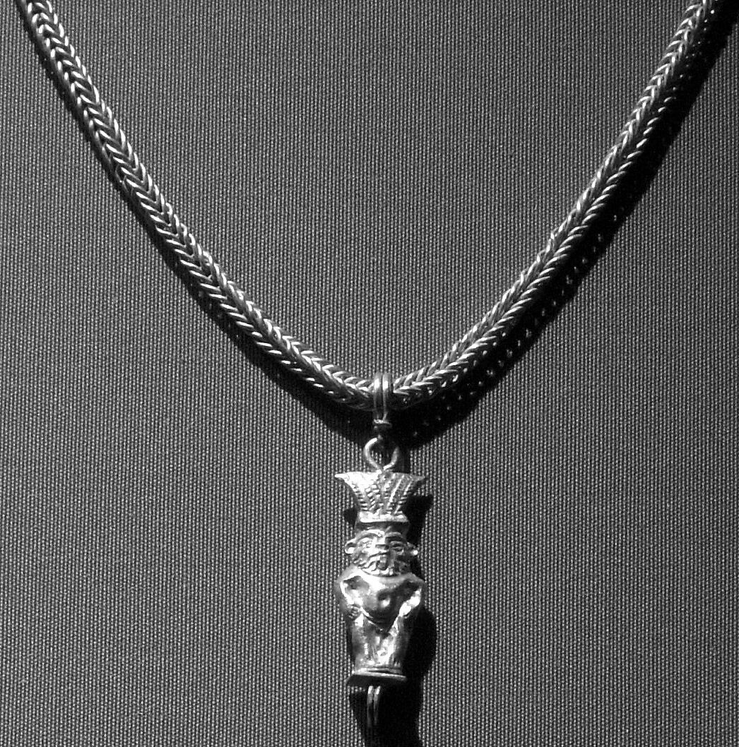 Loop-in-loop chain with intricate openwork medallion at the clasp and a gold Bes pendant, Gold