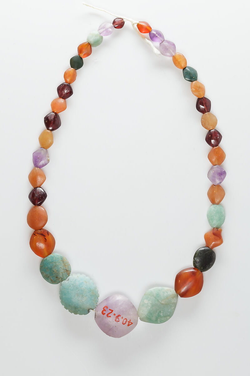 String of beads, Carnelian, garnet, green feldspar, amethyst, green jasper, black and white mottled stone