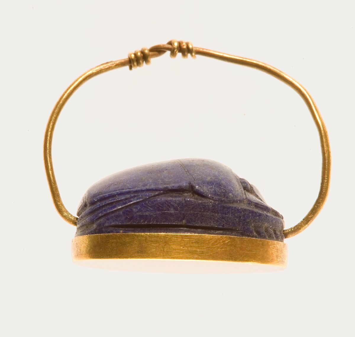 Scarab Finger Ring, Lapis lazuli scarab set in gold plate and on a gold wire ring
Lapis-lazuli