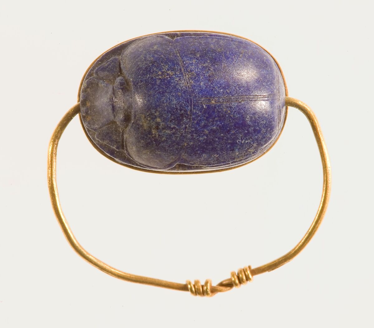 Scarab Finger Ring, Lapis lazuli scarab set in gold plate and on a gold wire ring
Lapis-lazuli 