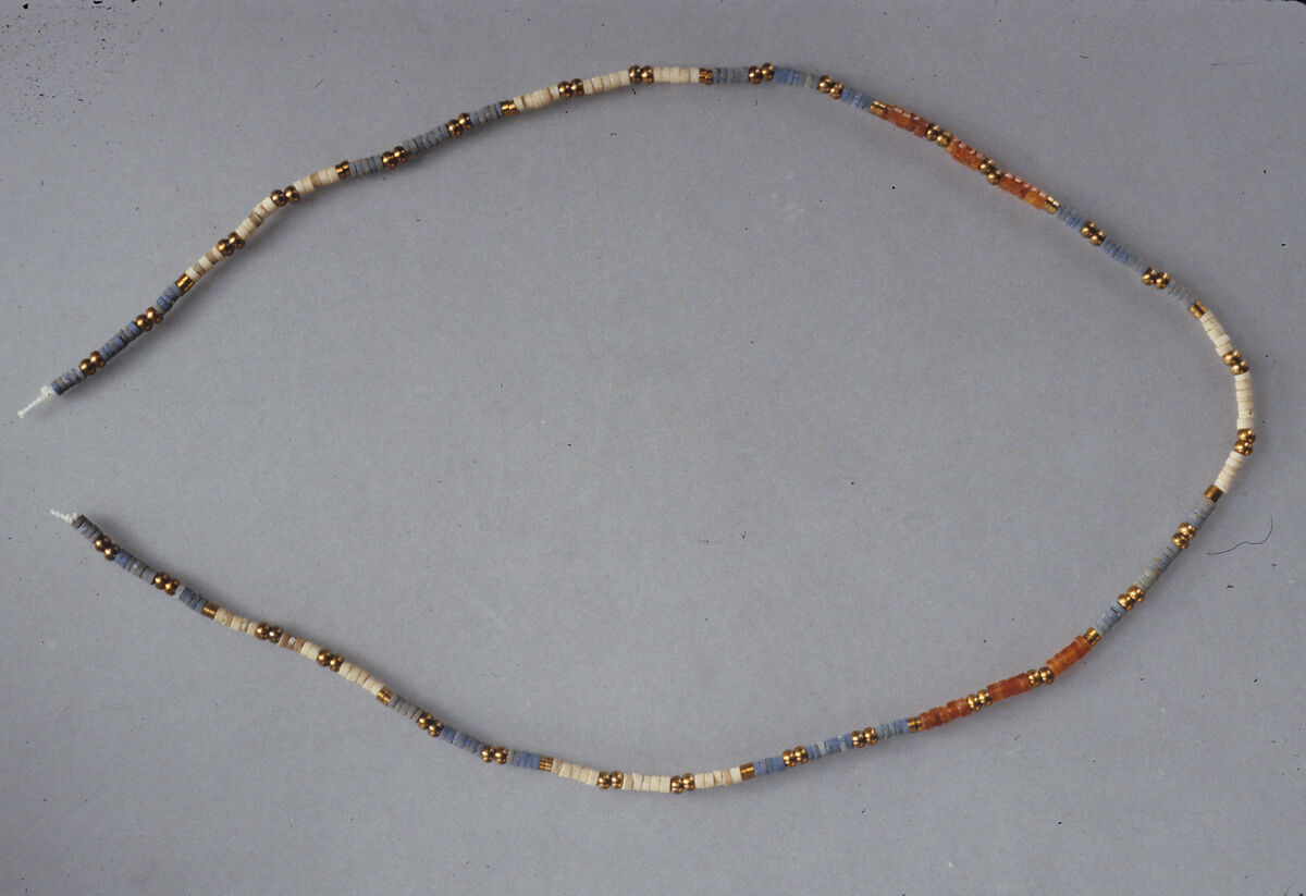 String of ring and ball beads of Hepy, Carnelian, paste, white stone, restored bronze