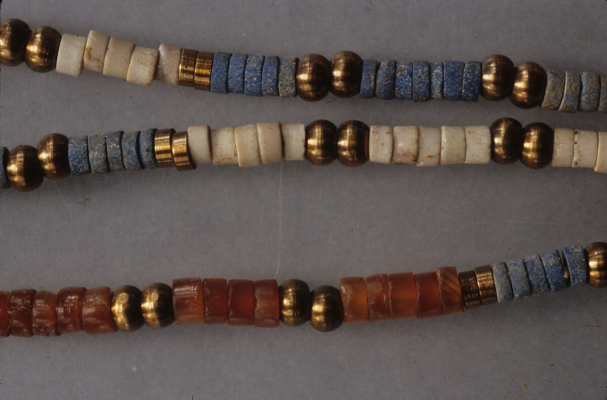 String of ring and ball beads of Hepy, Carnelian, paste, white stone, restored bronze