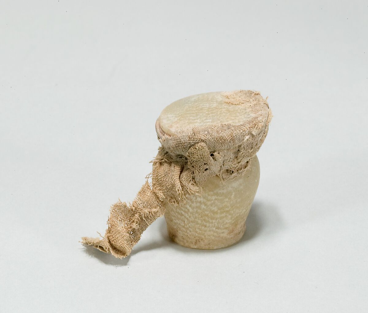Kohl jar, Travertine (Egyptian alabaster), linen 
