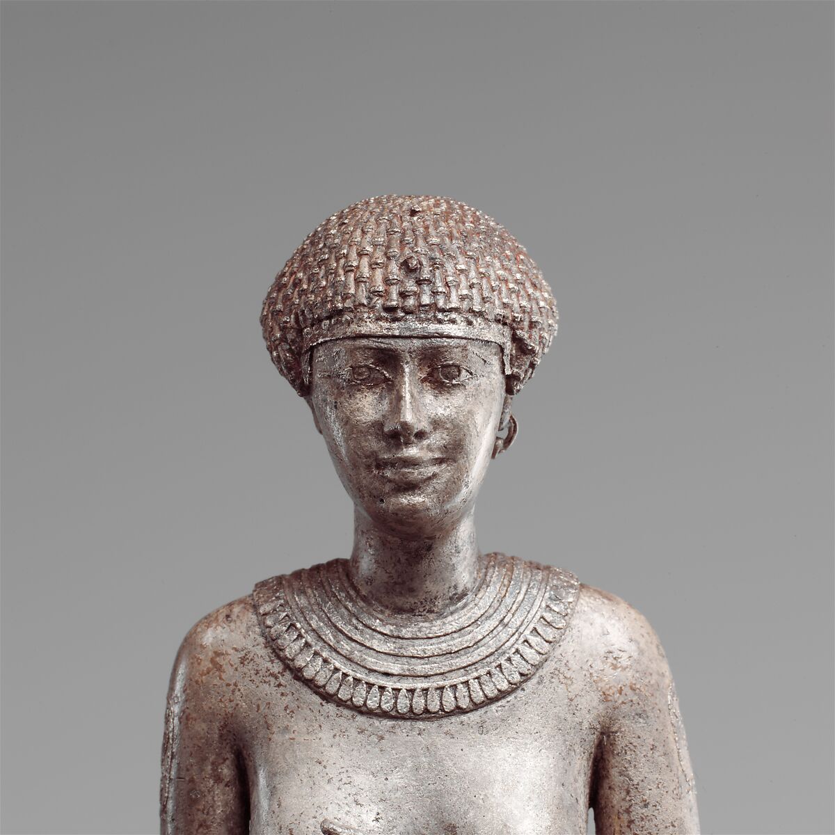 Statuette of a Royal (?)  Woman with the Cartouches of Necho II on her Arms, Silver