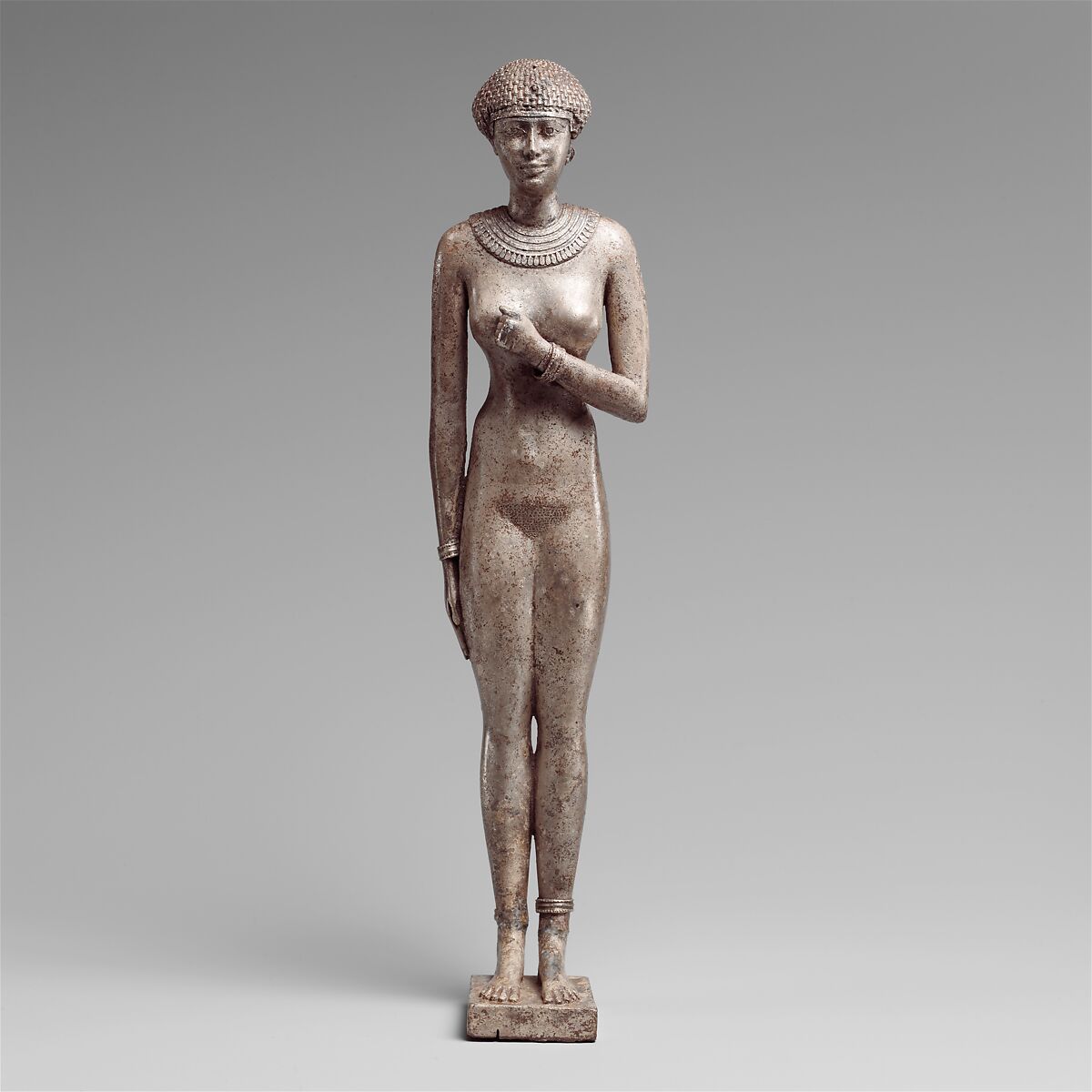 Statuette of a Royal (?)  Woman with the Cartouches of Necho II on her Arms, Silver 