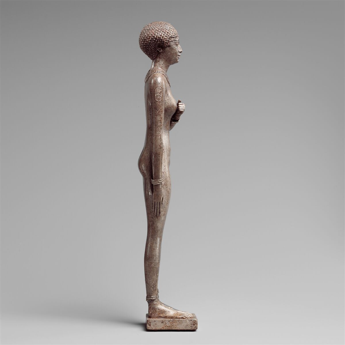 Statuette of a Royal (?)  Woman with the Cartouches of Necho II on her Arms, Silver