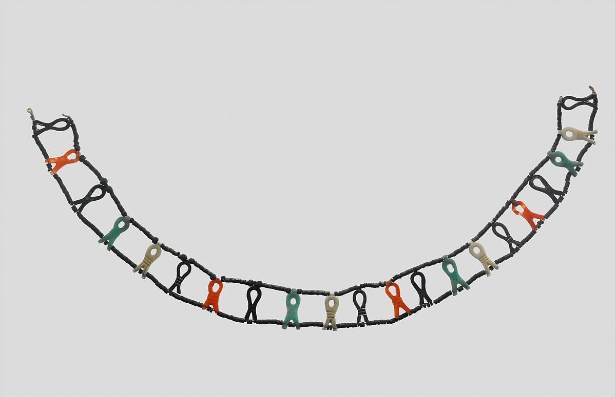 Necklace with Sa-Amulets of Senebtisi, Sa-amulets: Silver (5 originals, 4 restored), carnelian, feldspar, turquoise, ivory (4 restored). Tiny disk beads: top row turquoise, bottom row restored
Ball beads: silver