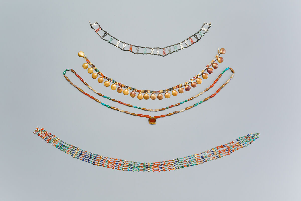Necklace with Sa-Amulets of Senebtisi, Sa-amulets: Silver (5 originals, 4 restored), carnelian, feldspar, turquoise, ivory (4 restored). Tiny disk beads: top row turquoise, bottom row restored
Ball beads: silver