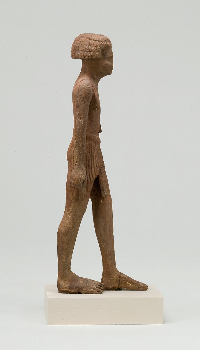 Statuette, striding man, Wood