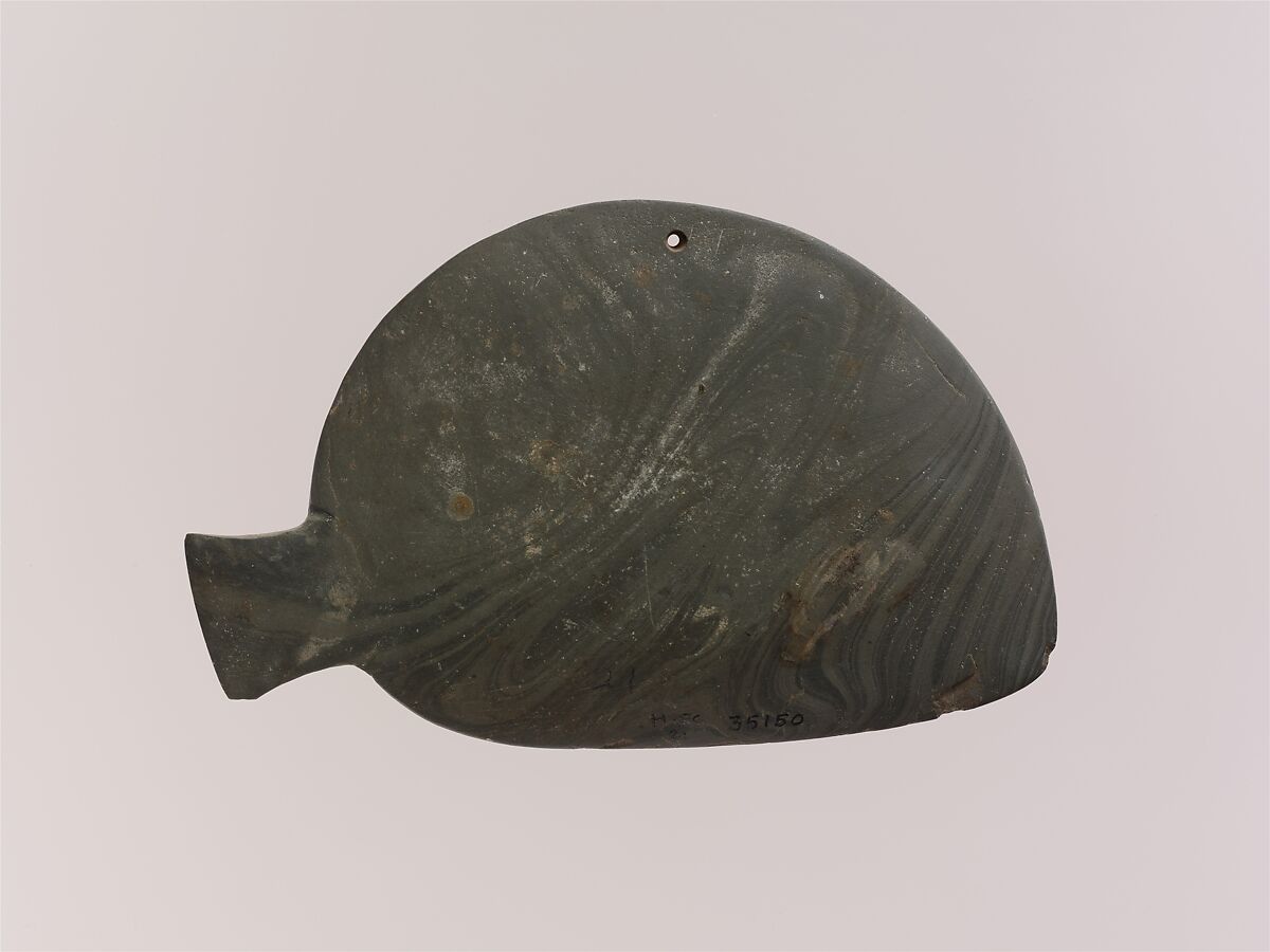 Fish-shaped palette with the remains of green pigment, Greywacke 