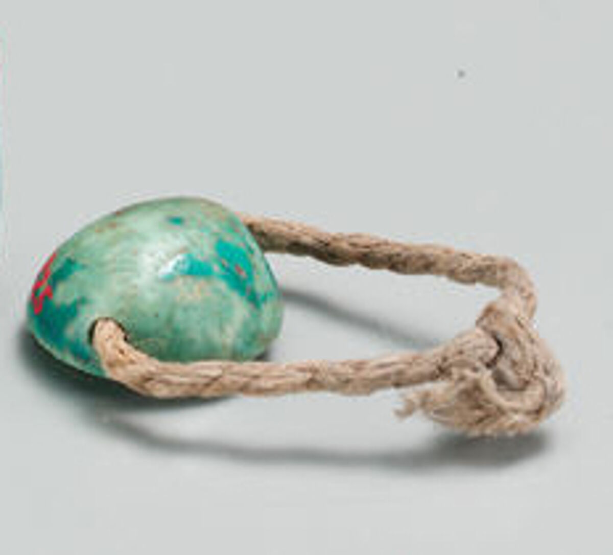 Cowroid ring, Glazed steatite, linen string