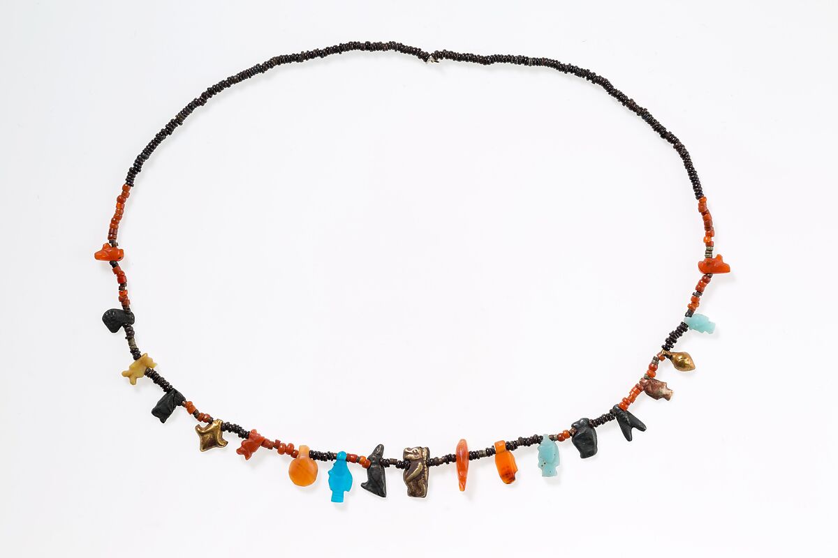 Necklace with disc beads and amulets, Carnelian, gold, silver, faience, glass, yellow stone, tin 