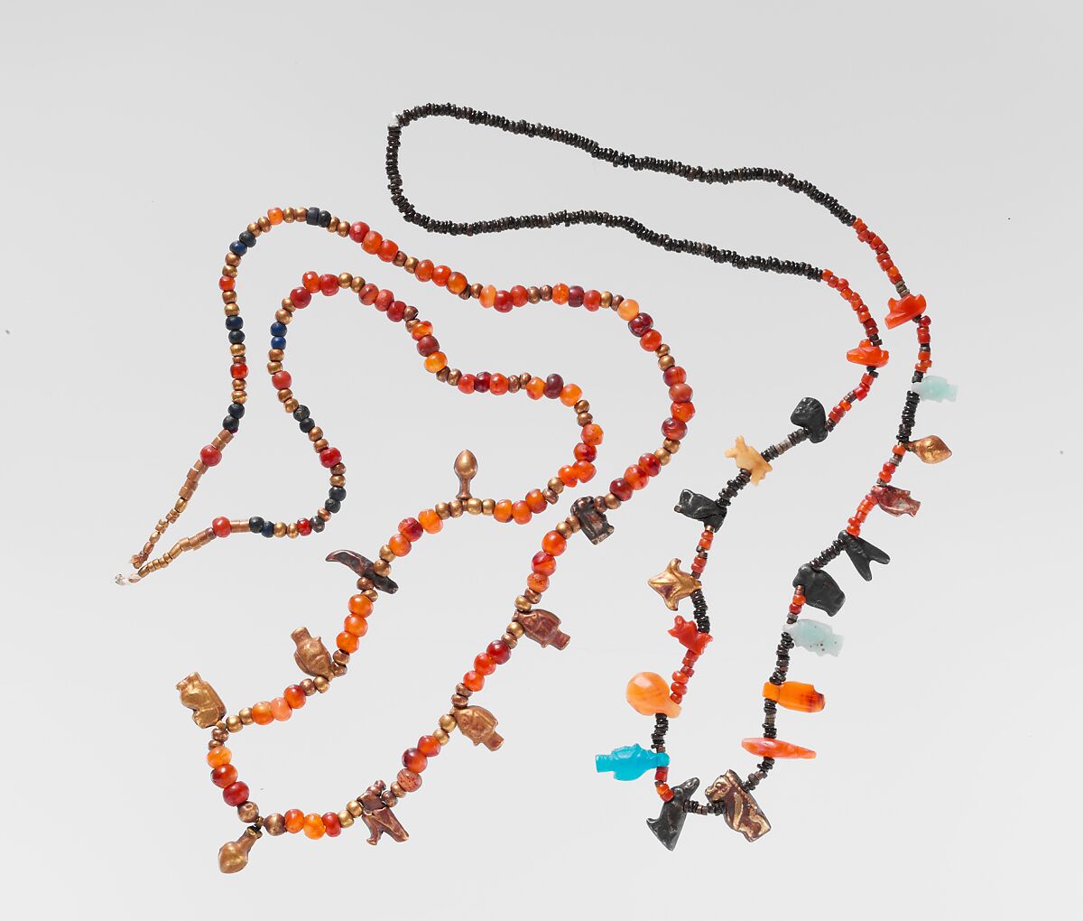 Necklace of ball beads and gold amulets, Gold over pitch, carnelian, lapis lazuli
Carnelian
Lapis-lazuli