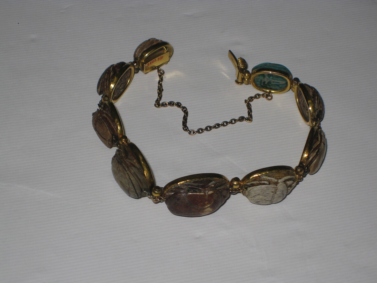 Nine scarabs set in modern bracelet., Glazed steatite, gold 