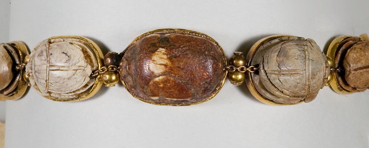 Nine scarabs set in modern bracelet., Glazed steatite, gold