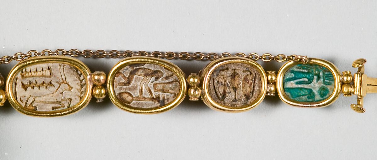 Nine scarabs set in modern bracelet., Glazed steatite, gold