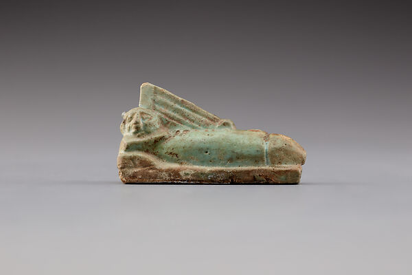 Figure with a sidelock strumming a harp on his phallus, faience
