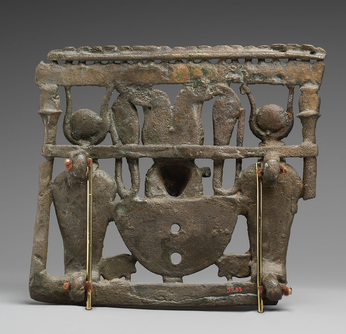 Pectoral with bovine head crowned with disk, horns and feathers, Cupreous metal, carnelian