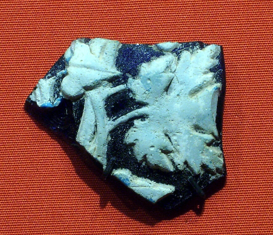 Cameo fragment with ivy and vine leaves from a skyphos (footed wine cup), cameo glass, white on blue 