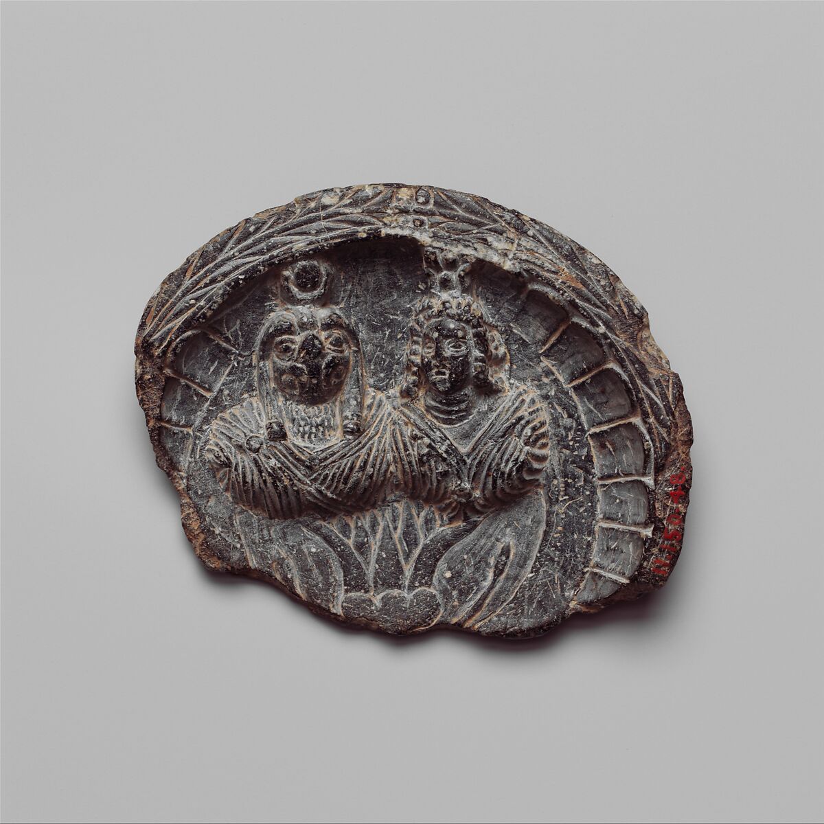 Shallow dish with high relief figures of Isis and falcon-headed Horus, Steatite 