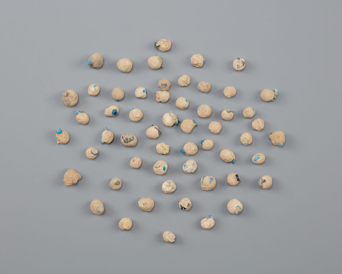 Tray of clay balls with embedded faience ring beads, Low-fired whitish clay, faience 