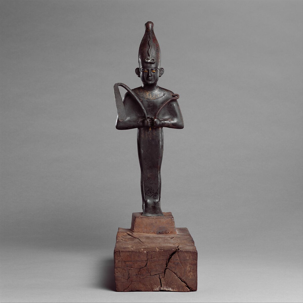 Osiris offered by the Astronomer of the House of Amun, Ibeb, Leaded bronze; precious-metal leaf; inlays of other materials; wood base with ink or black paint inscription