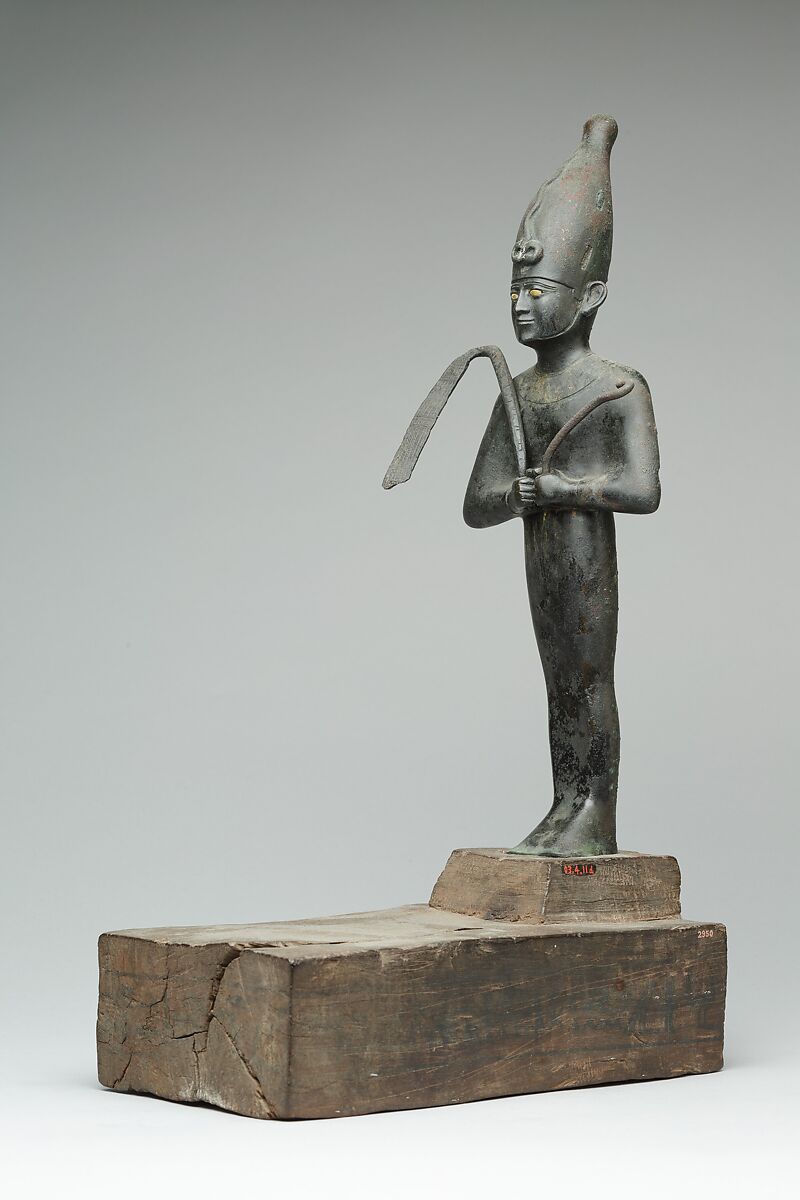 Osiris offered by the Astronomer of the House of Amun, Ibeb, Leaded bronze; precious-metal leaf; inlays of other materials; wood base with ink or black paint inscription