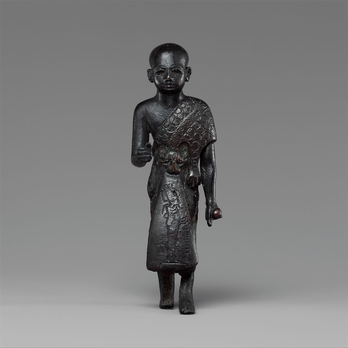 Priest in a leopard skin cloak with an inscription and Osiris on his skirt, Leaded bronze