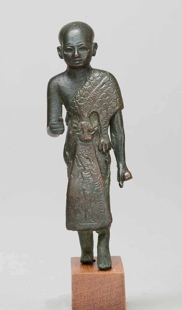 Priest in a leopard skin cloak with an inscription and Osiris on his skirt, Leaded bronze