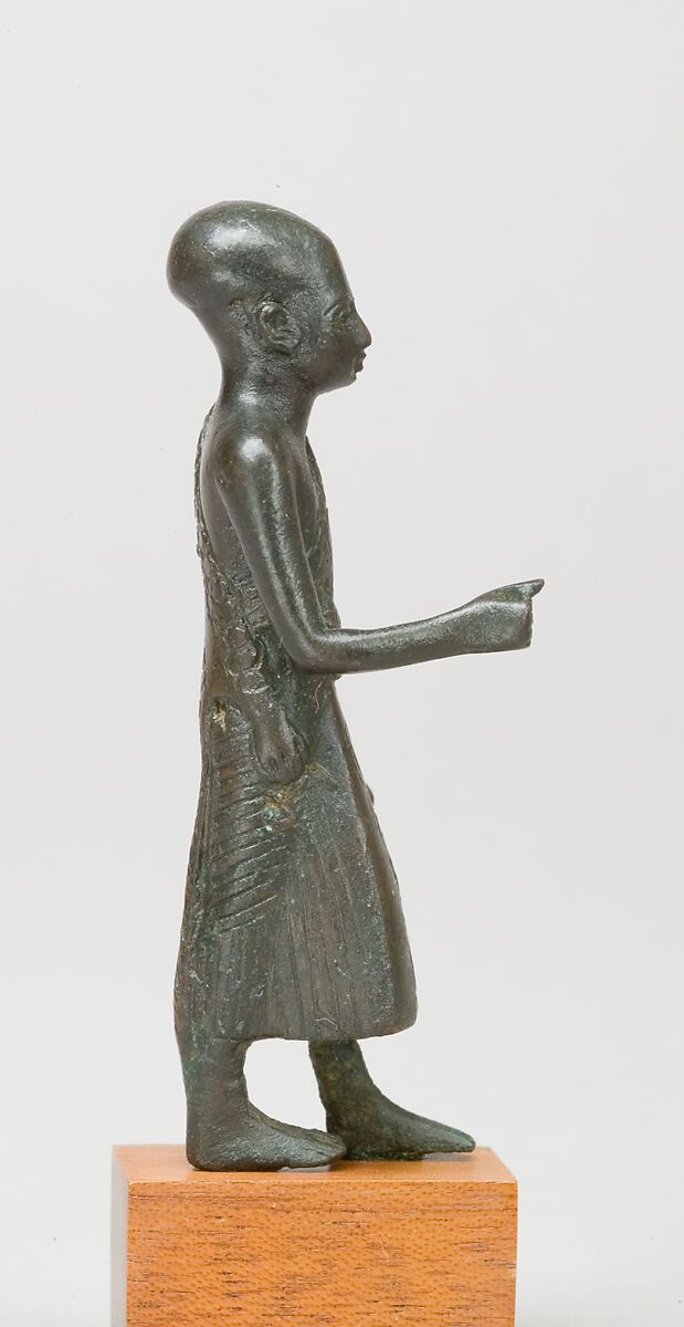 Priest in a leopard skin cloak with an inscription and Osiris on his skirt, Leaded bronze