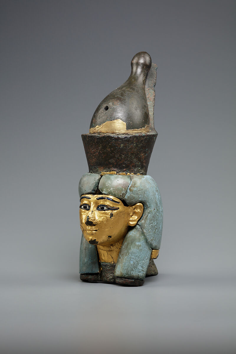 Attachment in the form of the head of a goddess wearing the double crown, Leaded bronze, gold and electrum sheet on crown, Egyptian blue and glass inlays