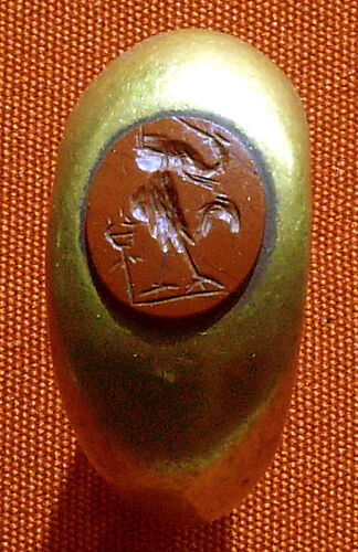 Ring with a gem with magical device of a composite figure with an unidentifiable object and a caduceus