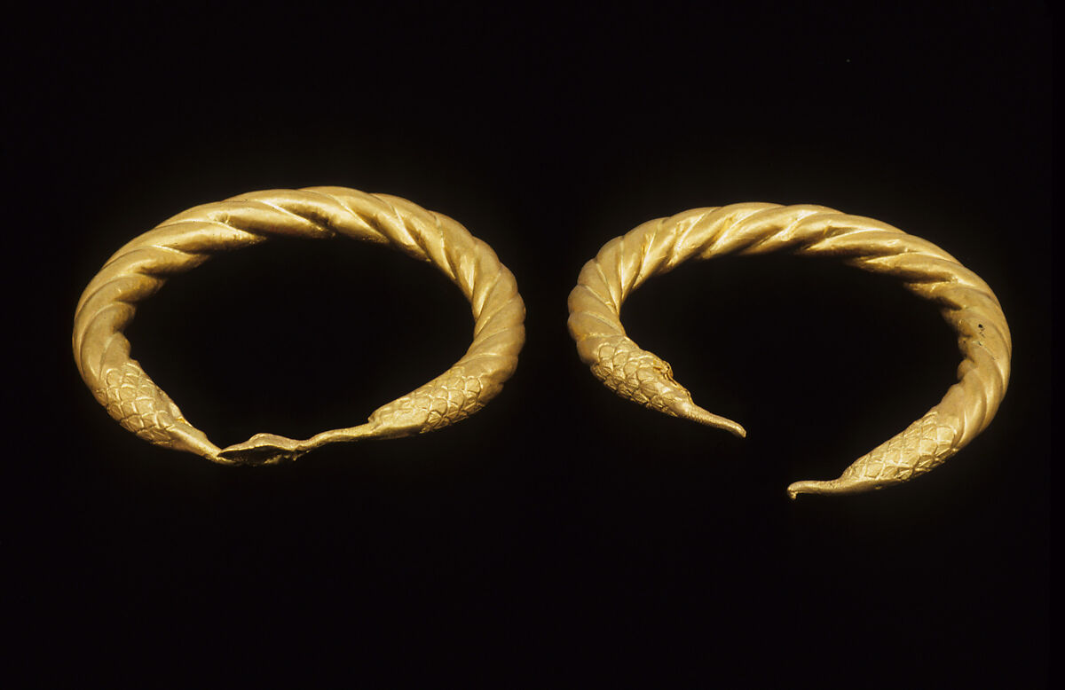 Spirally twisted tubular armlet with one goose-head terminal preserved, gold 