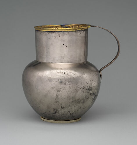 Silver jug with gold rim