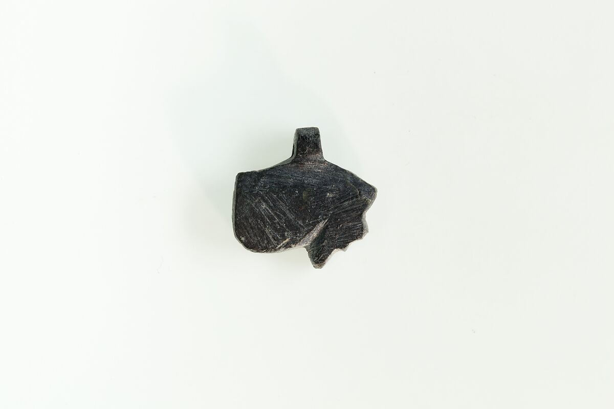 10 Amulets: 1 wedjat, 1 scarab, 3 djed pillars, 1 incised plaque, 1 uraeus, 2 wadj signs, and 1 cylindrical bead, Lapis lazuli, stone, carnelian, glass