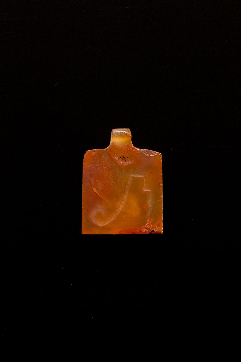 10 Amulets: 1 wedjat, 1 scarab, 3 djed pillars, 1 incised plaque, 1 uraeus, 2 wadj signs, and 1 cylindrical bead, Lapis lazuli, stone, carnelian, glass