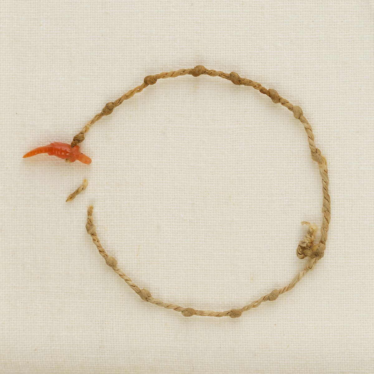Bracelet with a crocodile amulet, Linen, carnelian 