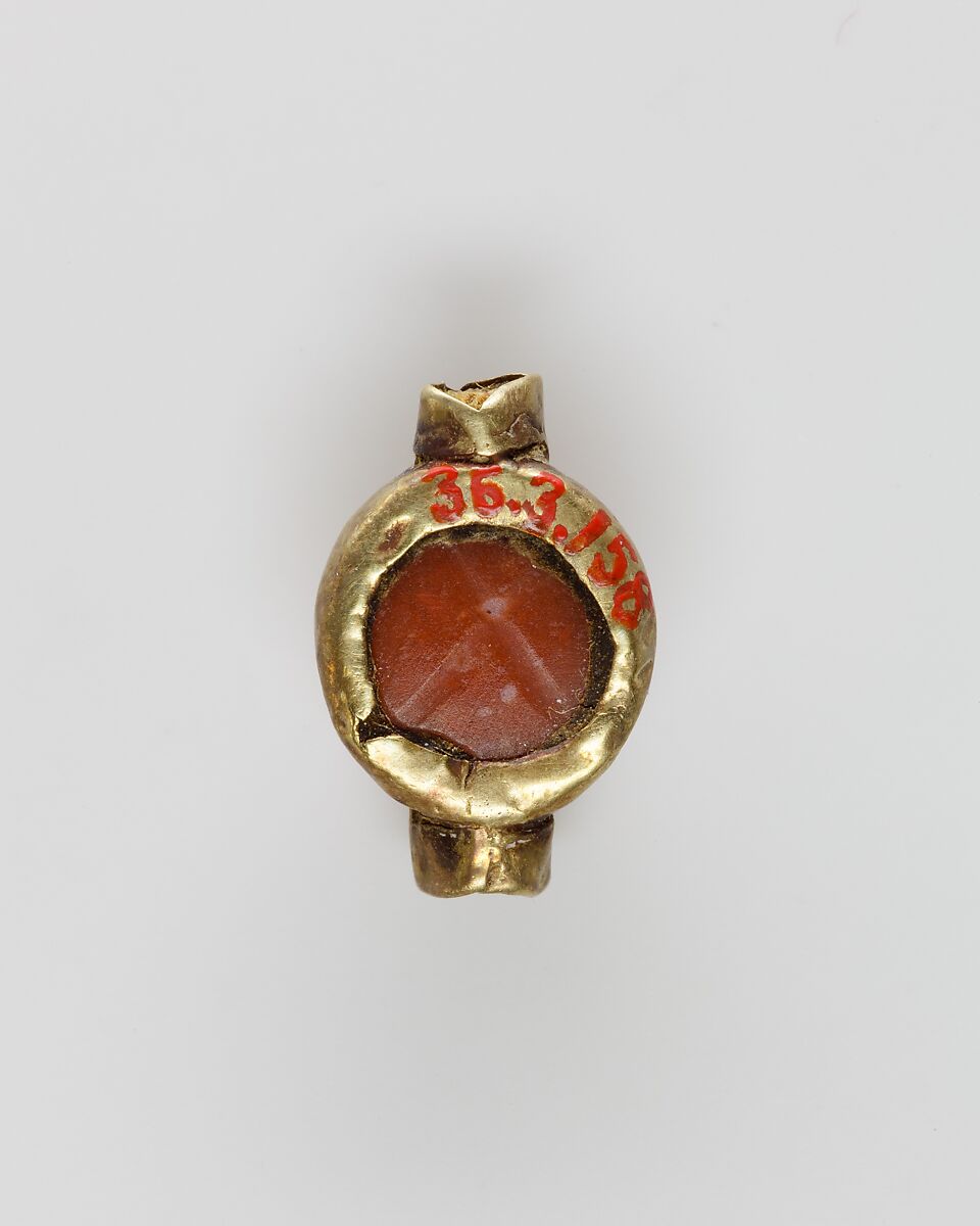 Scarab set in a ring bezel, carnelian, gold