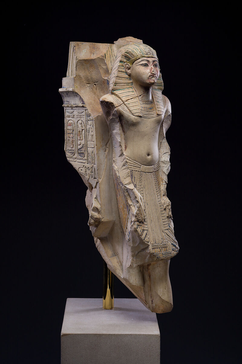 Figure of a king as part of a group proffered by an official of Ramesses II, Limestone, paint