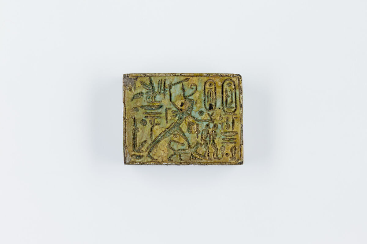 Oblong Plaque Depicting Ramesses II Smiting Enemies, opposite side relief scene of Isis and Nephthys flanking falcon labeled Horus son of Isis, Glazed steatite 