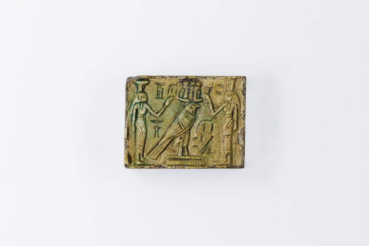 Oblong Plaque Depicting Ramesses II Smiting Enemies, opposite side relief scene of Isis and Nephthys flanking falcon labeled Horus son of Isis, Glazed steatite