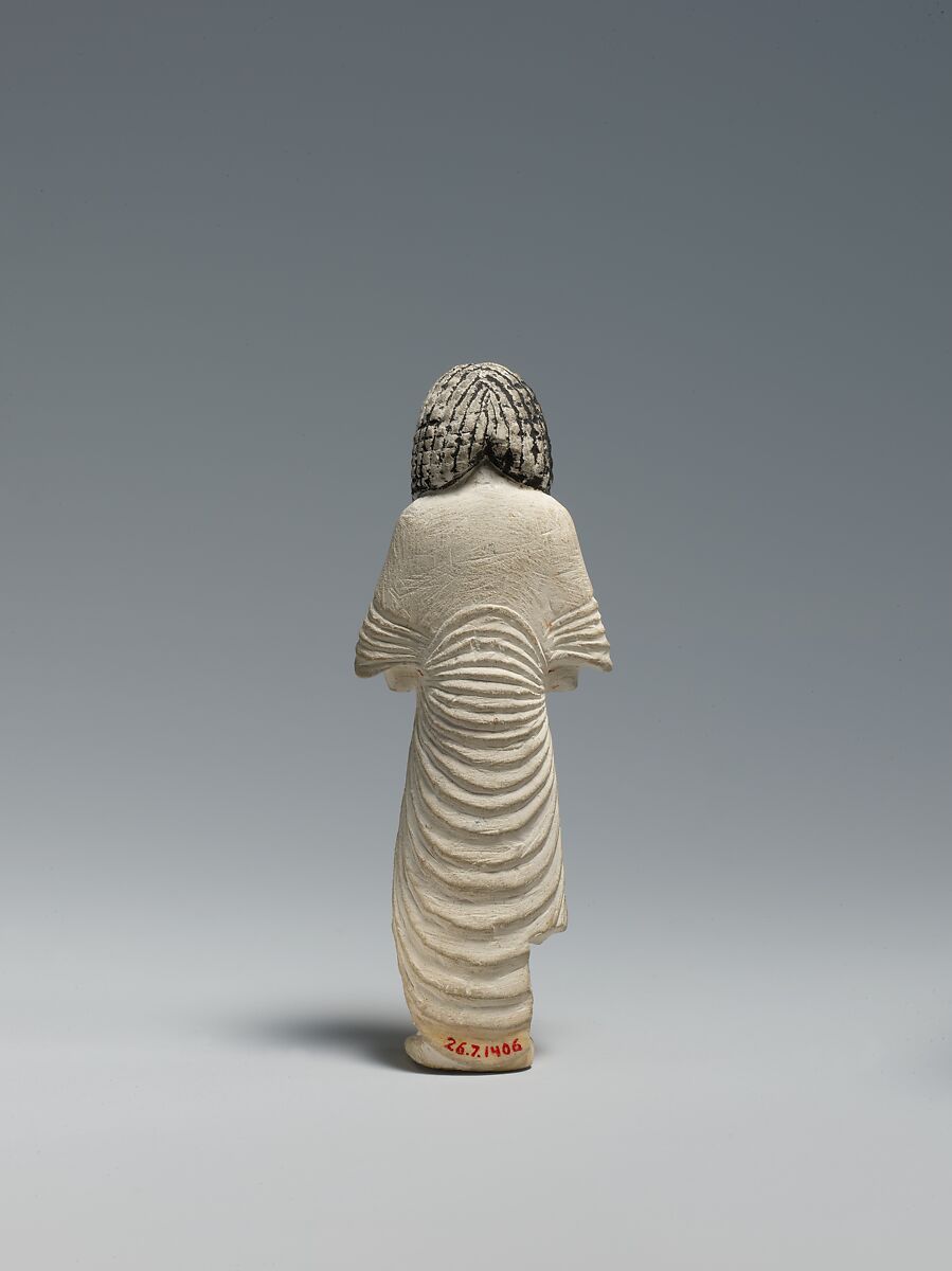Shabti of the Scribe Huy wearing a Bat-pendant, Limestone, pigment