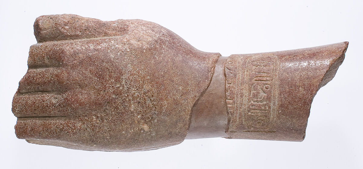 left hand and arm fragment with Aten cartouches from a statue supporting a stela?, Red quartzite 